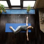 Image showing lady doing yoga on a wood floor.