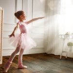 Image showing a young ballerina dancing on a wood floor.