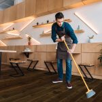 Image showing a man cleaning wood floor.