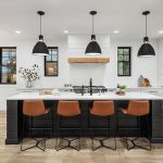 Image showing Johnson Hardwood's SPC flooring in color Malvasia set in modern Scandinavian style kitchen with bar style seating and natural sunlight.
