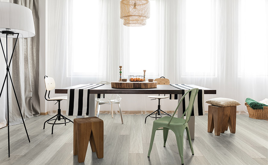 Image showing wood flooring in a minimalistic room interior with table and chairs with large open window and natural sunlight.